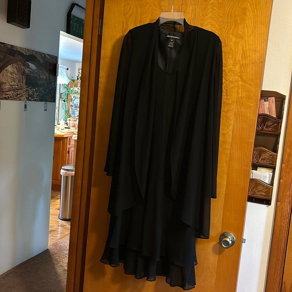 Size 12 black dress. One piece sheath with shear overlay! It is like new.